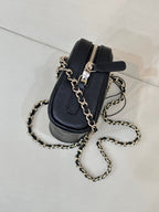 Chanel small quilted bag in dark blue with black strap detail and gold-tone chain