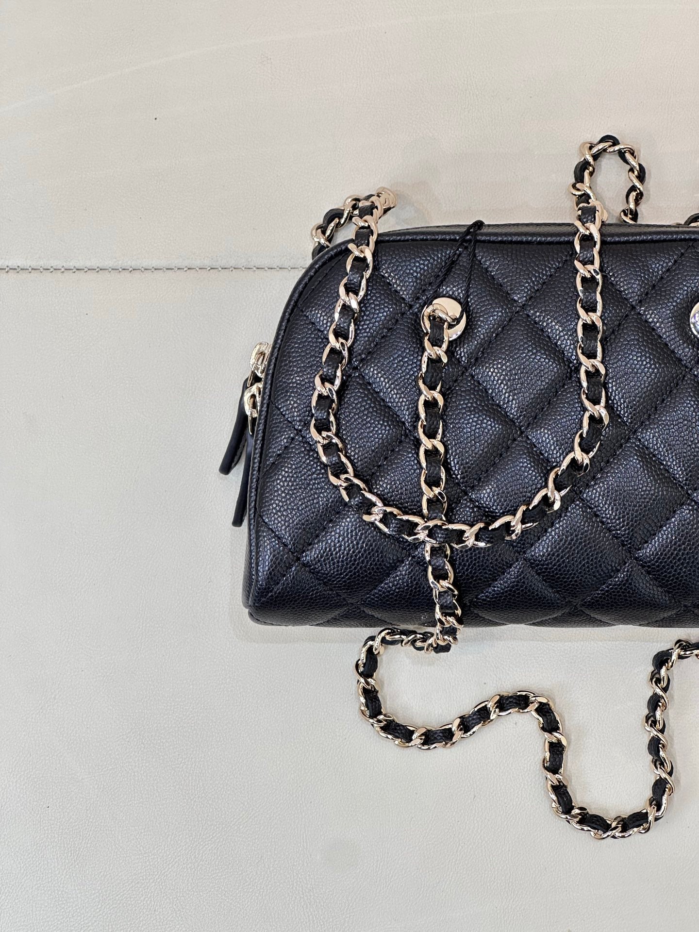 Chanel quilted bag in dark blue with front quilting, chain strap, and gold-tone charm