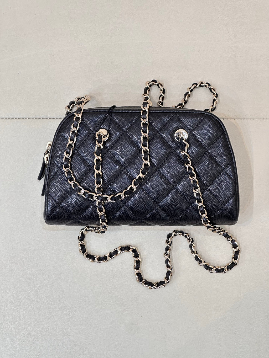 Chanel quilted crossbody bag in dark blue with multiple chain straps and zipper top