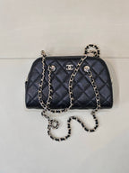 Chanel quilted bag in dark blue with chain straps and gold-tone logo accents