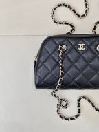 Chanel quilted crossbody bag, dark blue, showing front quilting and chain strap hardware