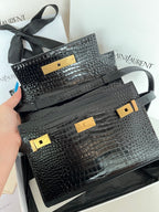 Black crocodile-embossed handbag with gold clasps and top handle