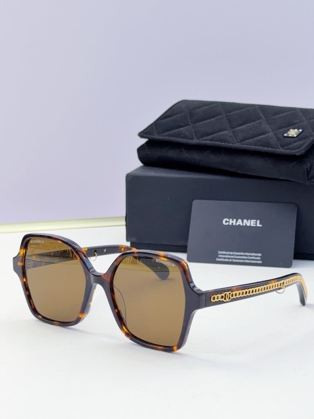 Eyeglasses with tortoise frame, amber lenses, gold chain temple, with case