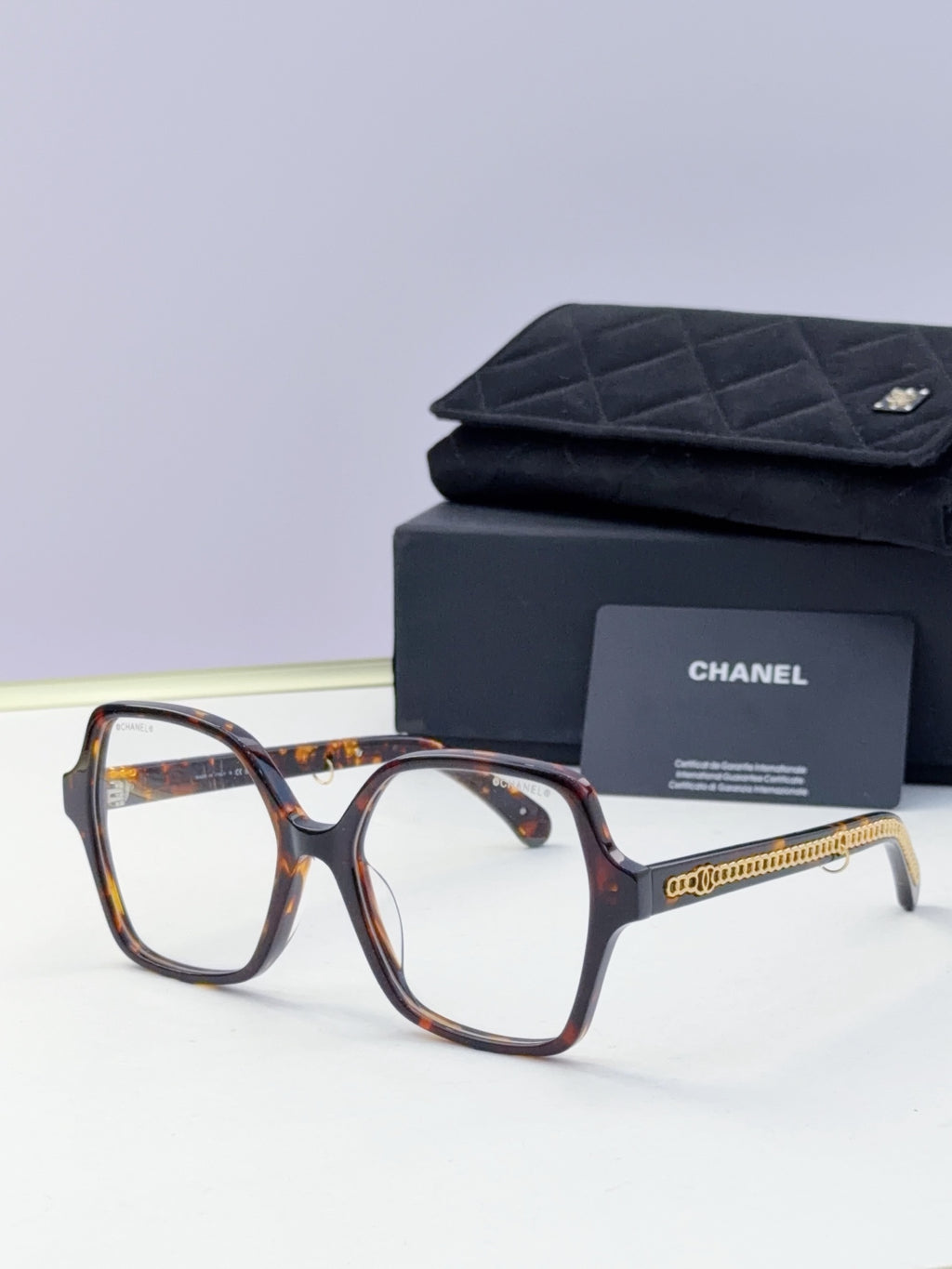 Eyeglasses with tortoise frame, gold-brown lenses, gold chain temple, with case