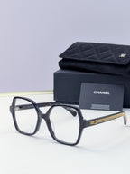 Eyeglasses with dark frame, clear lenses, gold chain temple, with case