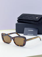 Tortoiseshell square sunglasses with amber lenses and gold chain temples