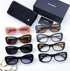 Assorted sunglasses with mixed frame colors and lens tints, shown together