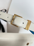 Ivory leather strap with gold-toned buckle, stitched holes, metal keeper detail