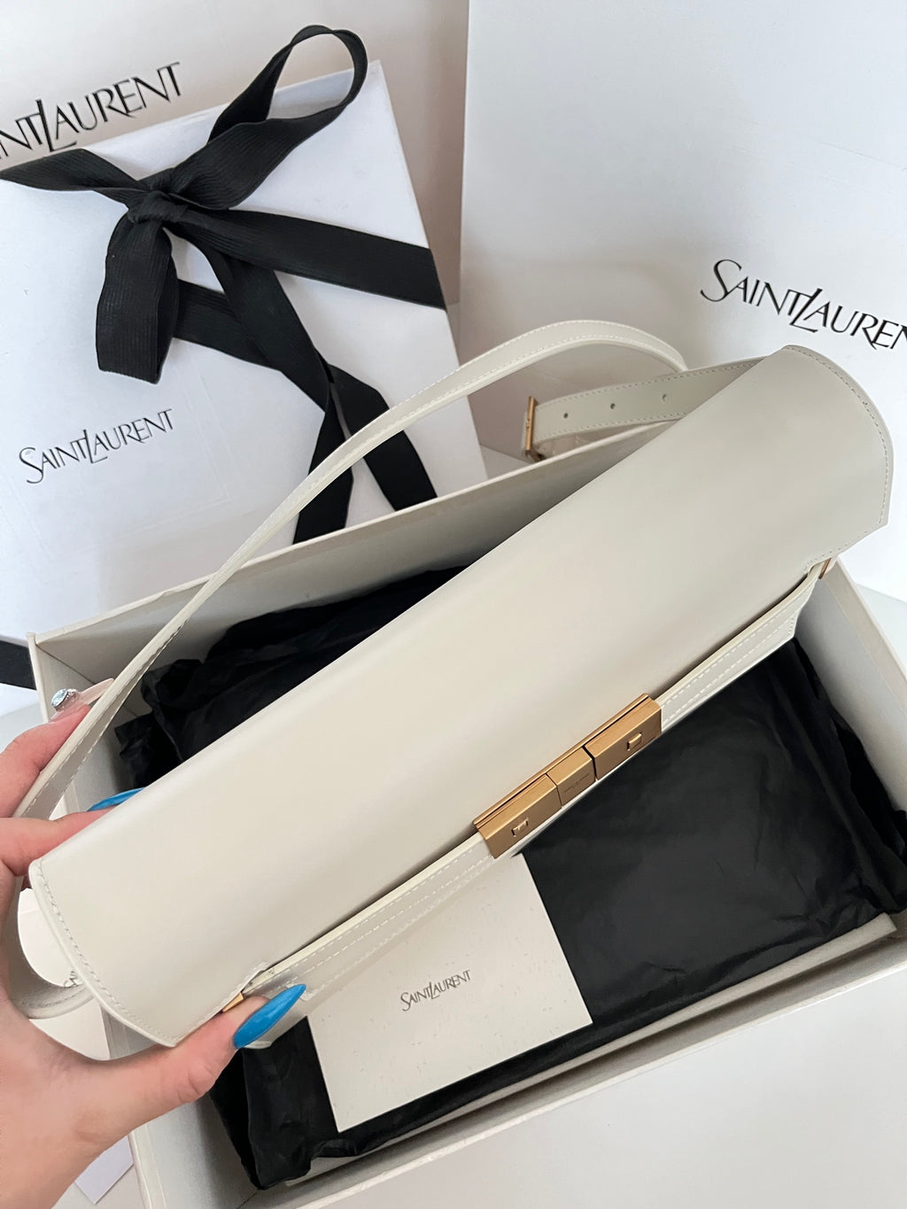Ivory leather shoulder bag open top view, gold bar closure, crossbody strap
