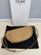 Celine crossbody bag in tan with front zip pocket, curved flap, gold-tone hardware