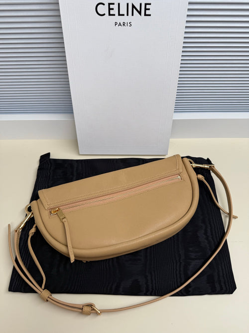 Celine crossbody bag in tan with front zip pocket, curved flap, gold-tone hardware