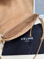 Celine crossbody bag in tan with top zip and tassel pull, adjustable strap