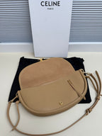 Celine crossbody bag in tan with rounded silhouette, zipper pull, adjustable strap