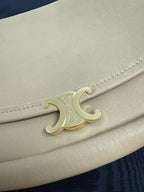 Celine bag hardware close-up: gold-tone C logo on tan leather flap