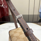 Handbag strap close-up with Gucci hardware, brown leather tab and adjustable buckle