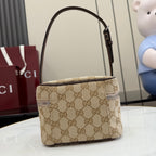 Handbag with beige GG canvas, dark leather strap detailing, top handle and zip closure