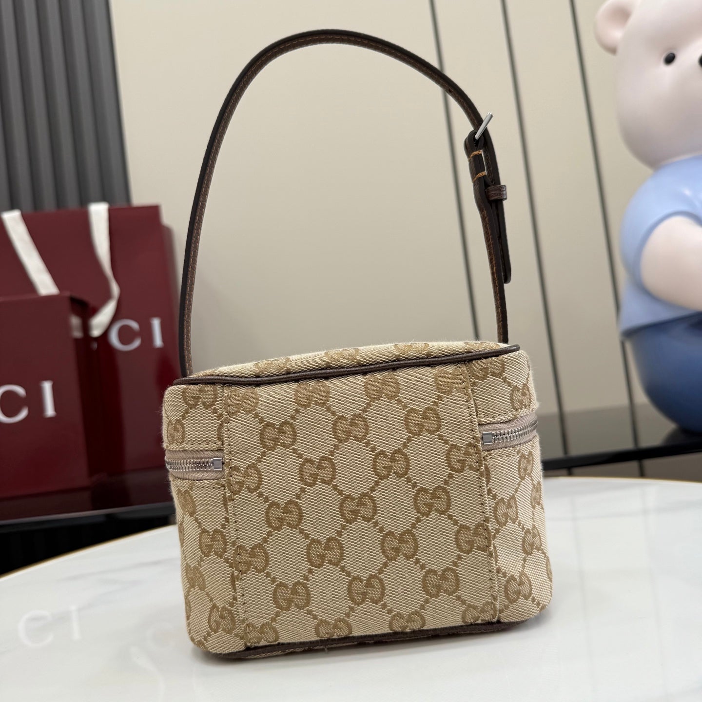 Handbag with beige GG canvas, dark leather strap detailing, top handle and zip closure