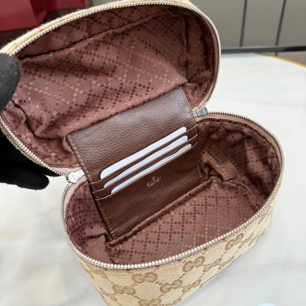 Handbag open interior with brown lining and card slots, top zip opening, beige GG exterior
