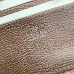 Handbag leather close-up with embossed Gucci logo on beige-brown textured leather panel