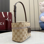Handbag with beige GG canvas, dark leather trim, top handle and side zip pull