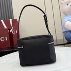 Black structured mini shoulder bag with top zip, front seams, and short handle