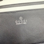 Black pebbled leather bag exterior with Gucci logo stamp and “made in Italy”