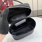Opened black mini bag interior with patterned lining and zip pocket compartments