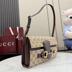 Gucci shoulder bag in GG canvas with dark leather strap and gold hardware detail