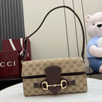 Gucci bag with GG canvas and dark leather trim, top handle, gold clasp hardware