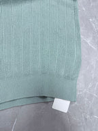 Light blue knit polo shirt hem with ribbed trim