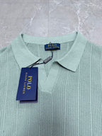 Light blue knit polo shirt collar with button placket and brand tag