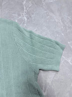Light blue knit polo shirt sleeve with textured ribbed knit