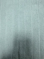 Light blue knit polo shirt fabric with fine vertical ribbed texture