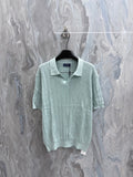Light blue knit polo shirt with ribbed collar and short sleeves