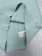 Light blue knit polo shirt folded with ribbed collar and short sleeves