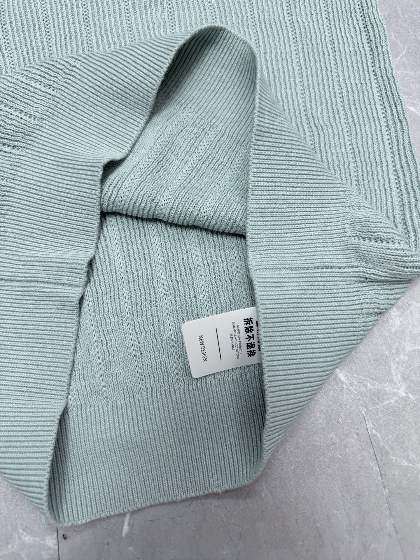 Light blue knit polo shirt folded with ribbed collar and short sleeves