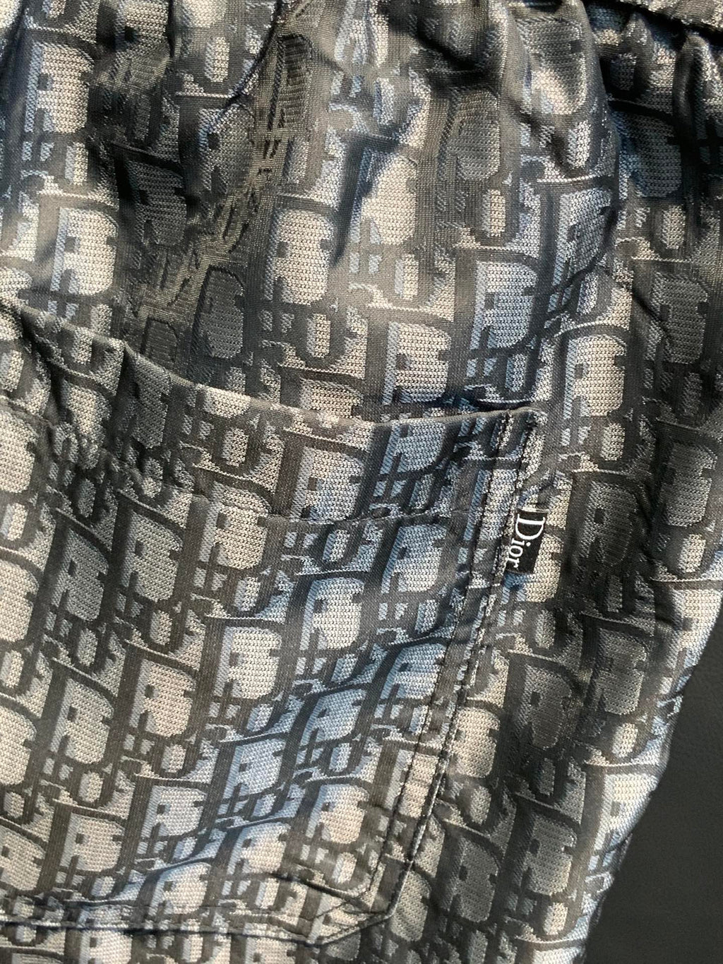 Dior monogram patterned pants fabric close-up with elastic waistband