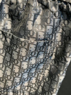 Dior monogram patterned pants fabric close-up with elastic waistband