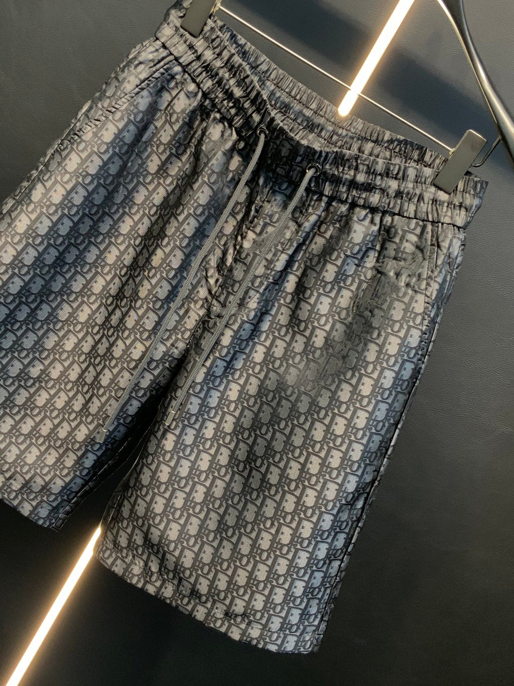 Dior patterned pants, angled view, gathered elastic waist and monogram print