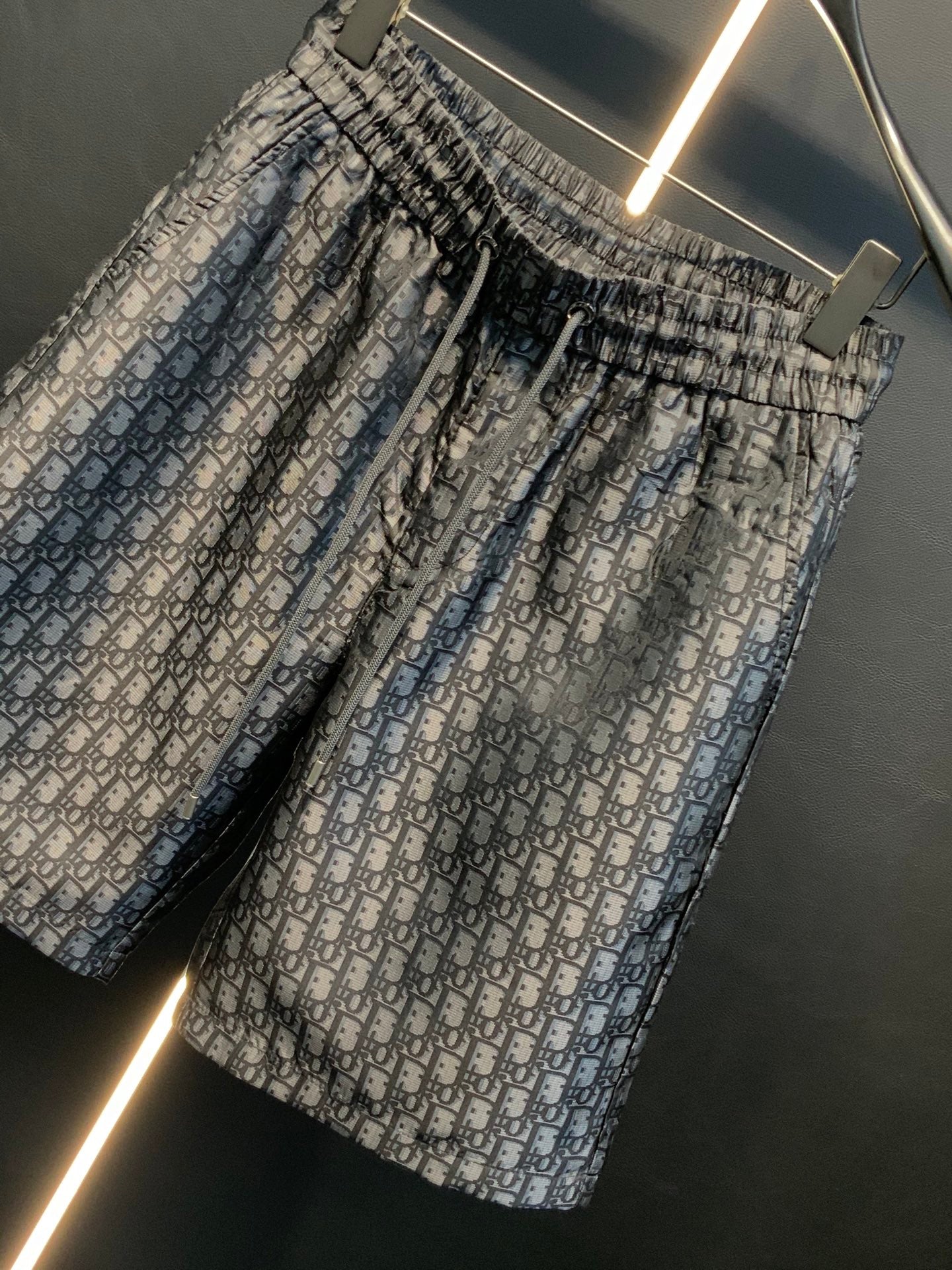 Dior patterned pants, angled view, gathered elastic waist and monogram print