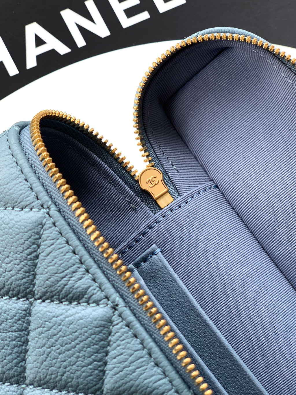 Chanel bag close-up: light blue interior with zip edge and logo tab
