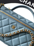 Chanel quilted bag close-up in light blue with gold zipper and chain detail