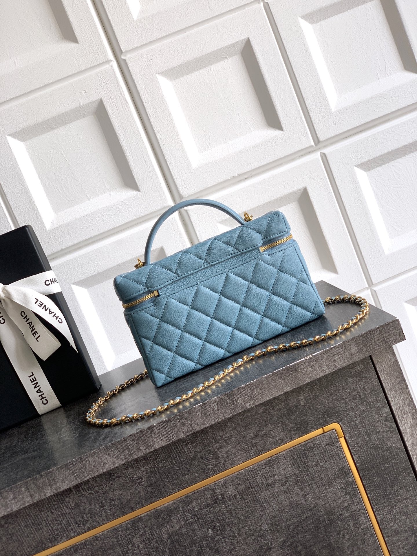 Chanel quilted handbag in light blue with front logo and gold-tone chain strap