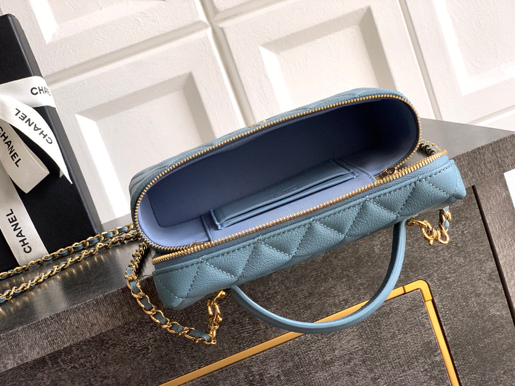 Chanel quilted bag open view in light blue with navy interior and chain strap