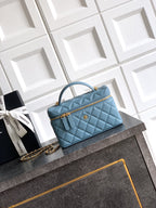 Chanel quilted handbag in light blue with top handle and gold-tone chain strap