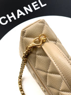 Beige quilted bag close-up with top clasp ring and gold zipper pull