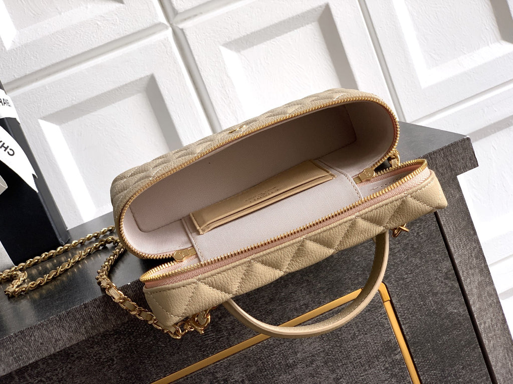 Light beige quilted handbag with open flap, interior pocket, and gold zipper