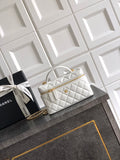 White quilted handbag with top handle and gold chain strap