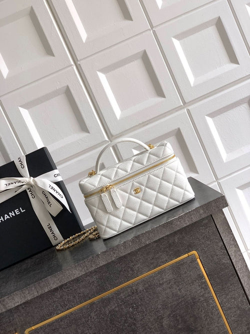 White quilted handbag with top handle and gold chain strap