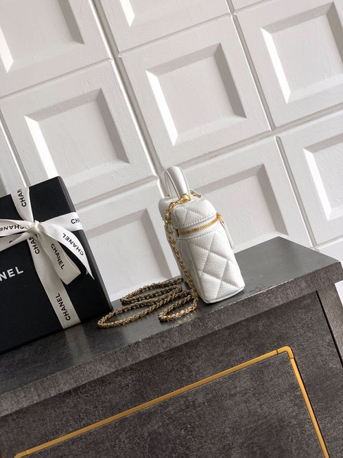White quilted mini handbag with gold top handle and chain strap